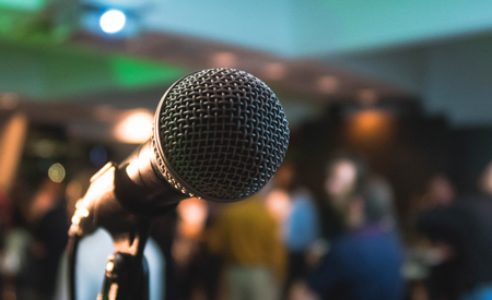 Photo of a microphone in a crowded room