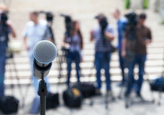 Photo of a crowd and microphone representing Ellis Strategies Crisis Management services